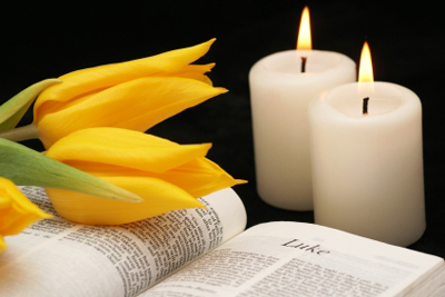 Open bible, tulips and candles